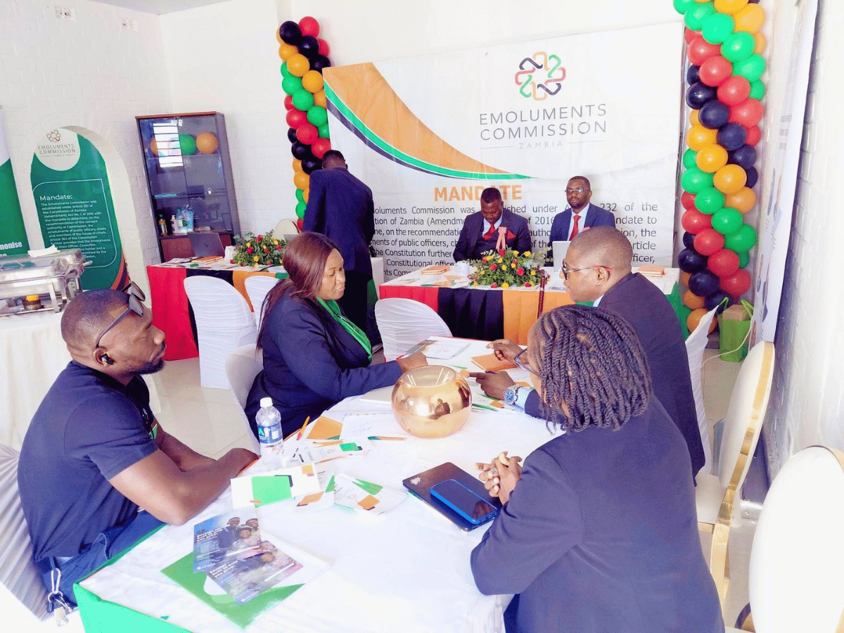 Members of the public engage with Emoluments Commission officials at the Zambia Hall exhibition stand during the 98th Zambia Agricultural and Commercial Show in Lusaka.