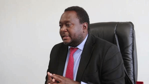 Dr. Namani Monze, Southern Province Permanent Secretary, seated at his office desk.