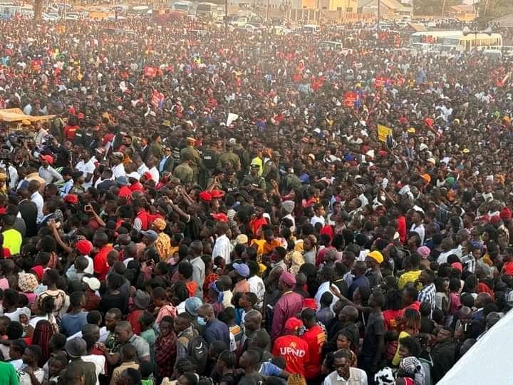 Crowds at a political rally contrasted with voters casting ballots at a polling station in Zambia, illustrating that elections are determined by votes rather than rally attendance.