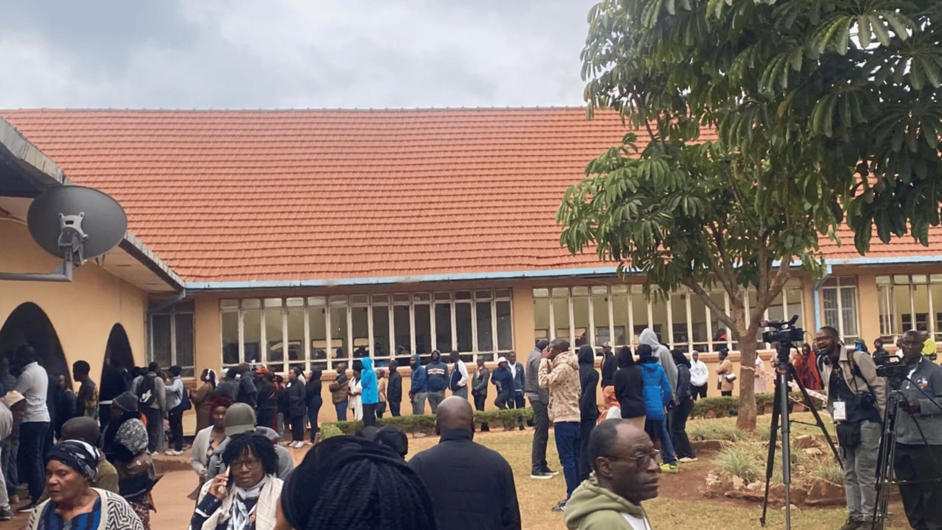 Voters queue in an orderly line at Kabulonga Secondary School polling station during Zambia's 2026 general election
