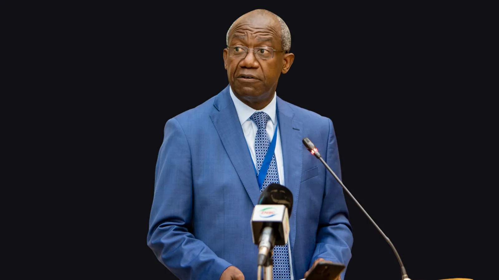 Secretary to the Cabinet Patrick Kangwa speaks to journalists on a ZNBC microphone during a press briefing on the Kabulonga security operation