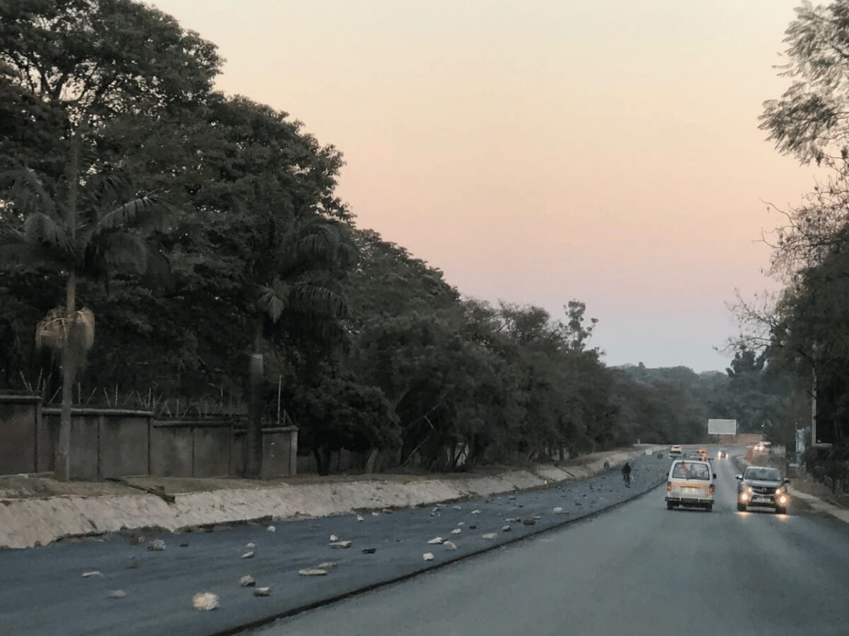 Commuters and vendors on a Lusaka street in the early morning