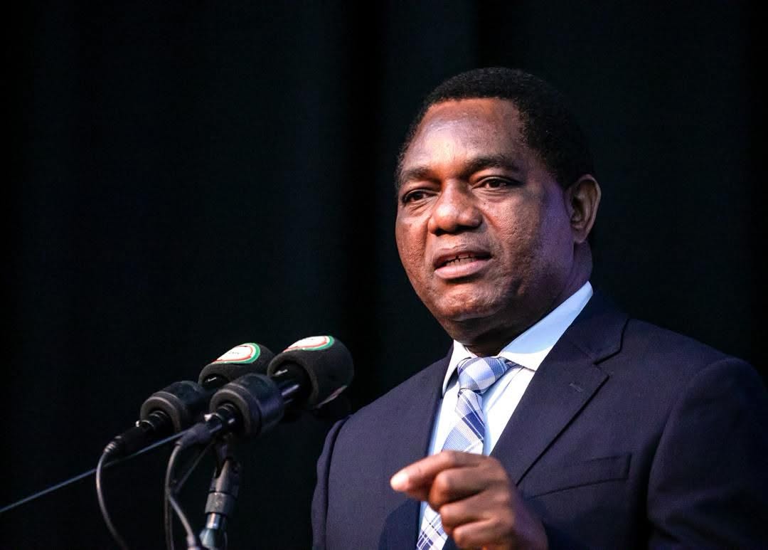 President Hakainde Hichilema speaking at a podium into microphones, addressing the nation on political violence ahead of Zambia's August 2026 elections