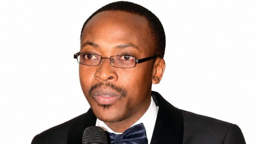 Brian Hapunda speaking into a microphone at a Chongwe West campaign event