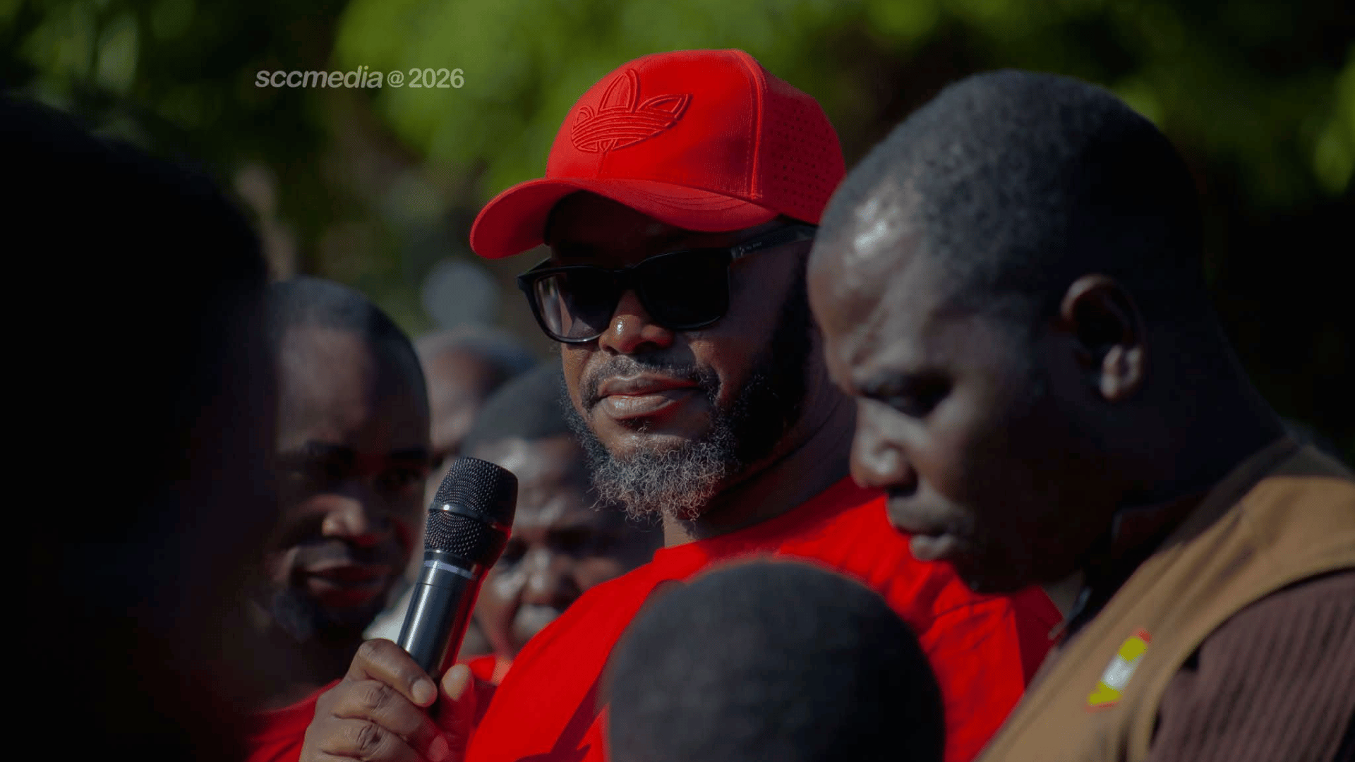 Sunday Chanda addresses supporters at a campaign rally in Kanchibiya, wearing a red cap and sunglasses