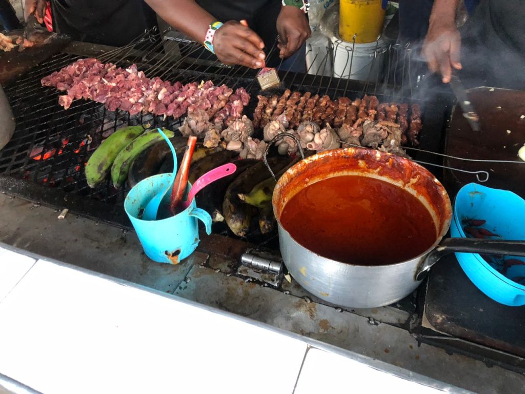 Zambia MSME development in practice: a young vendor bastes goat meat skewers at Desire, Nyumba Yanga, Lusaka