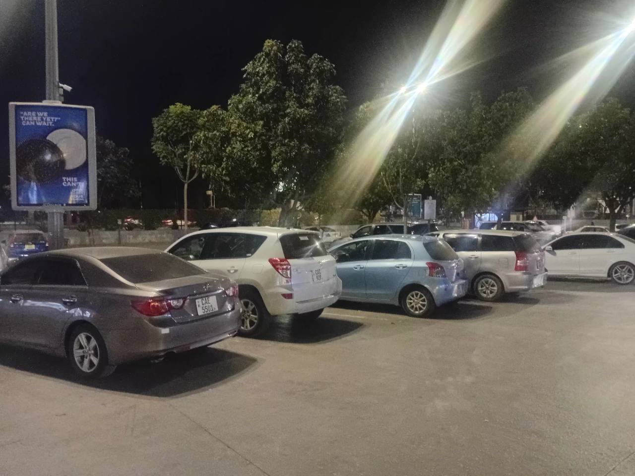 Vehicles occupying the illuminated Centro Mall parking area in Kabulonga, Lusaka, at night