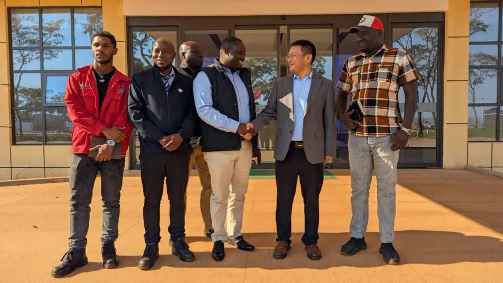 Clarence Chisuku shakes hands with a Sinomine Kitumba representative during a meeting in Mumbwa.