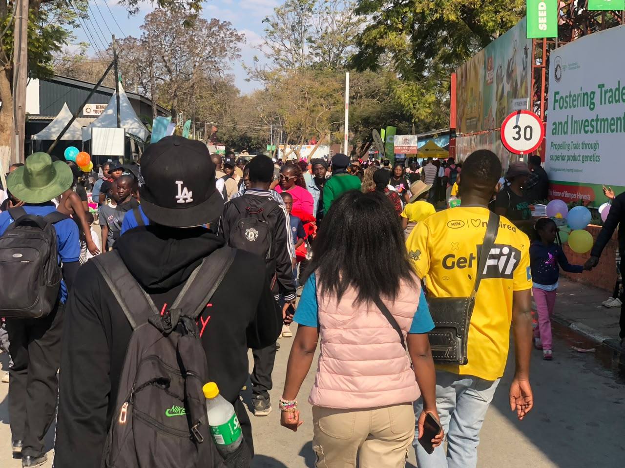 Crowds moving along an internal avenue at Lusaka Showgrounds during the 2026 Agricultural and Commercial Show