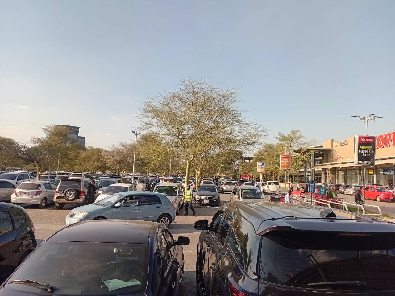 Vehicles navigating a busy section of the East Park Mall parking area in Lusaka