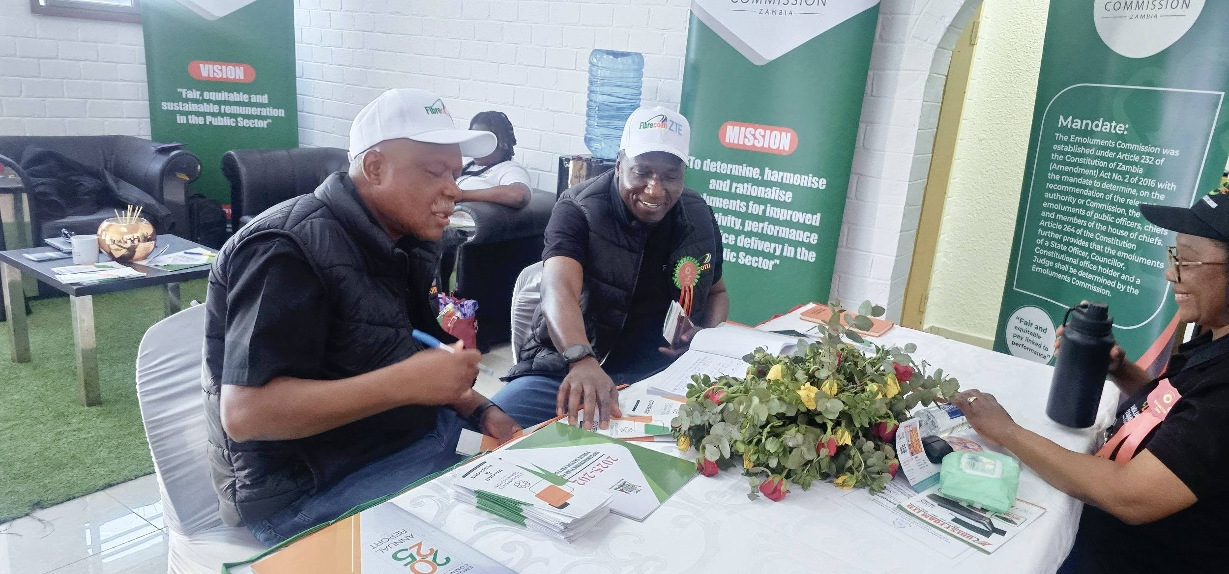 Visitors reviewing Emoluments Commission information materials