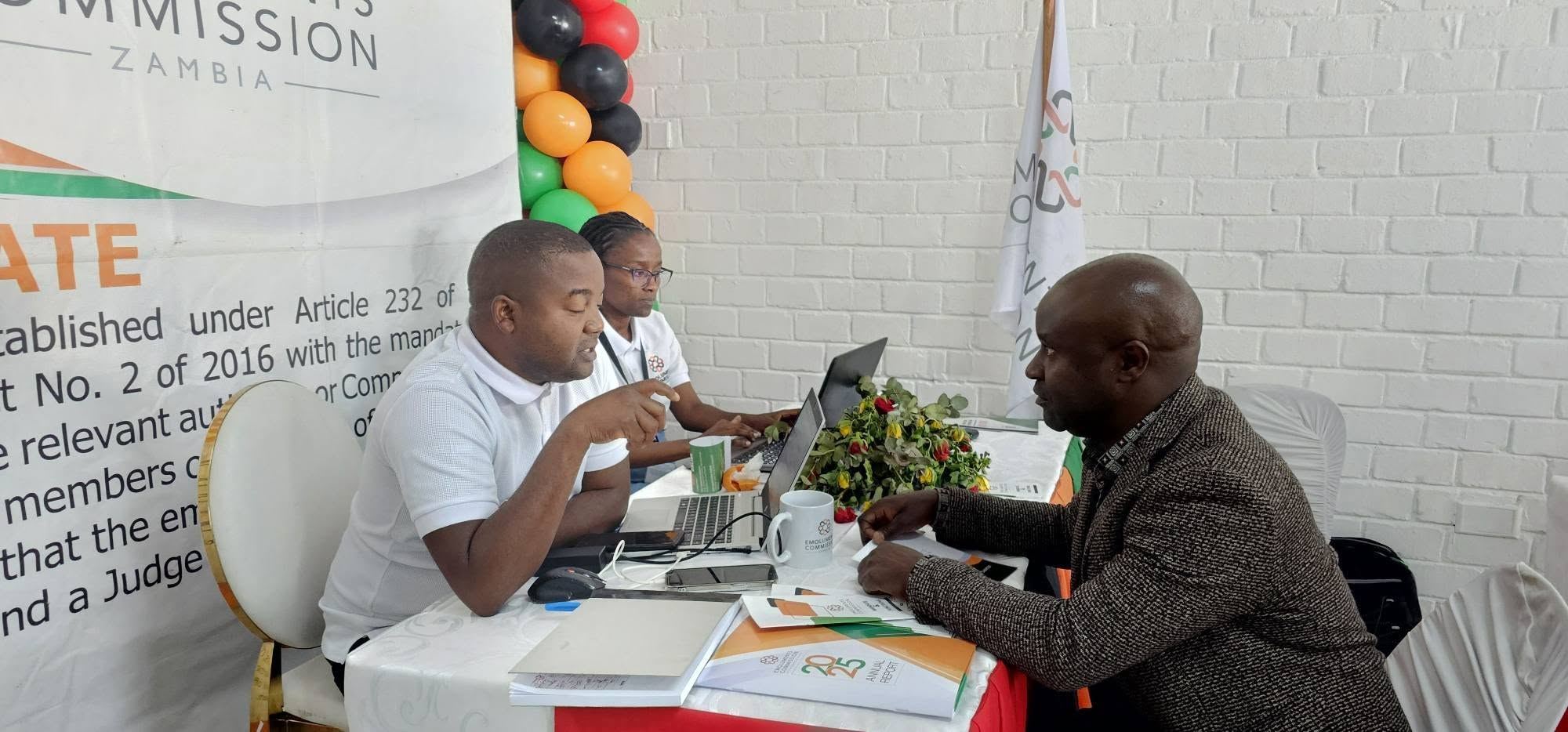 A visitor consulting Emoluments Commission staff at the Agricultural and Commercial Show