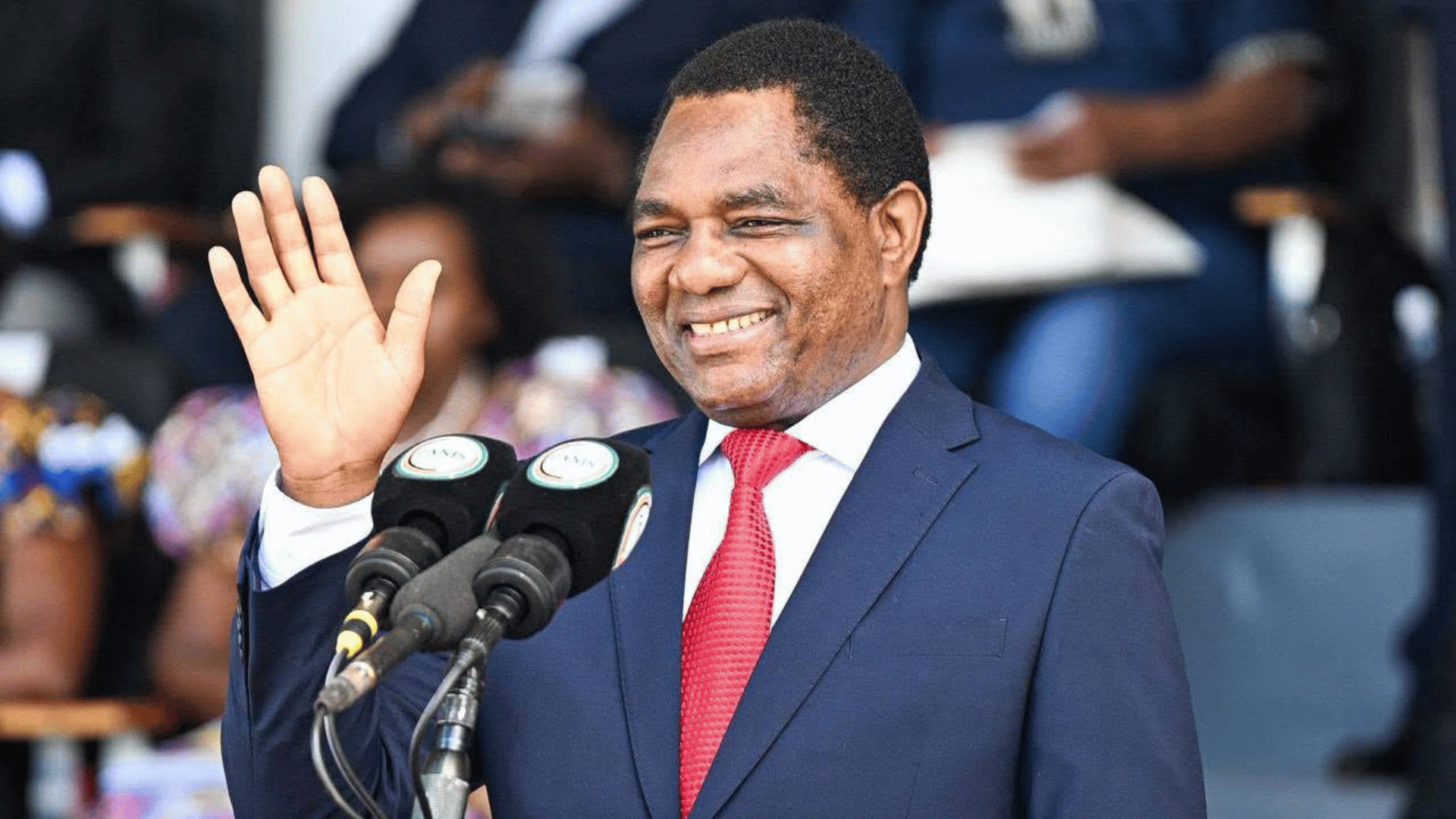 President Hakainde Hichilema waving at a ZNBC microphone podium after his 2026 re-election as declared by the ECZ on 18 August 2026