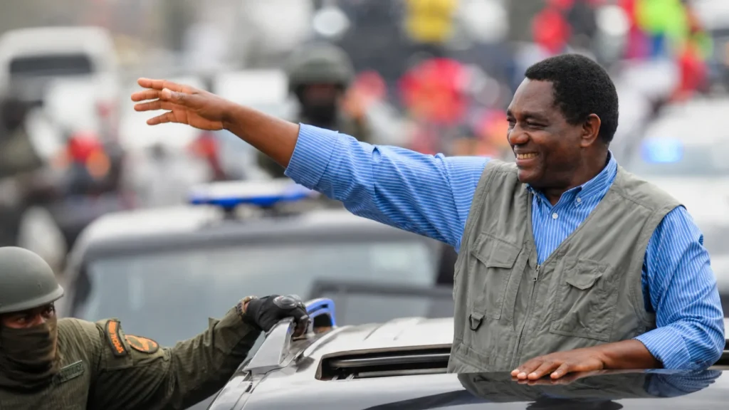 Hakainde Hichilema waves from a vehicle before his second-term inauguration in Zambia