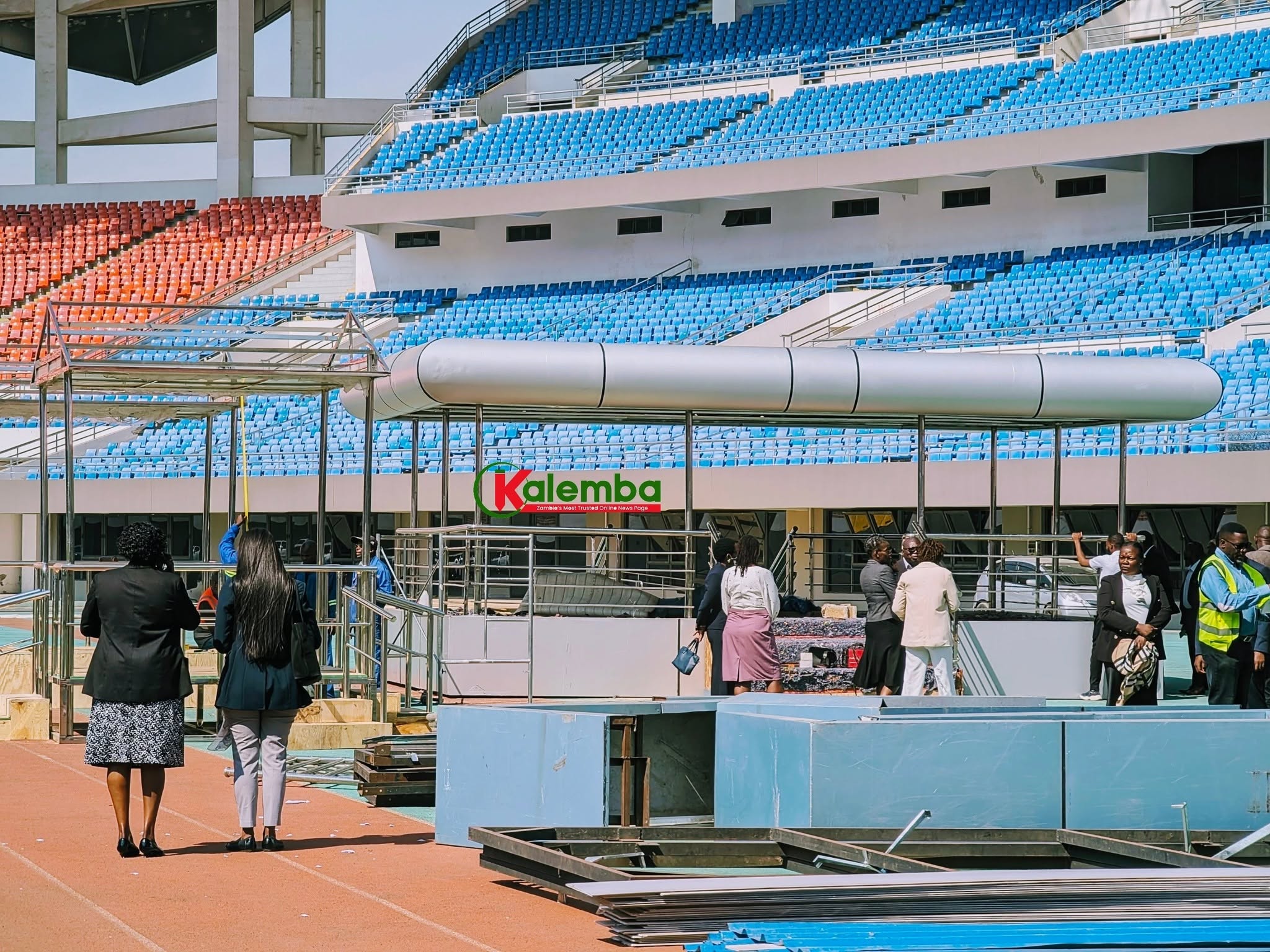Workers and officials at National Heroes Stadium as inauguration preparations continue