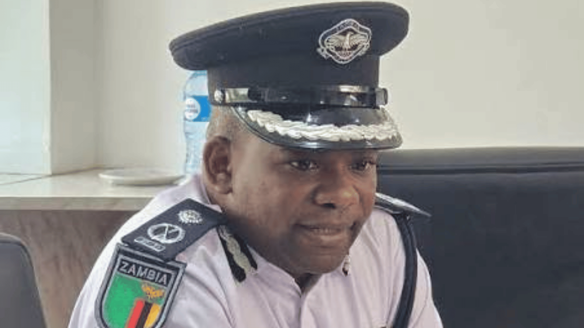 Zambia Police Service officer in uniform reporting the fire that gutted about 20 makeshift trading structures at Kamwala Trading Area in Lusaka on 18 August 2026