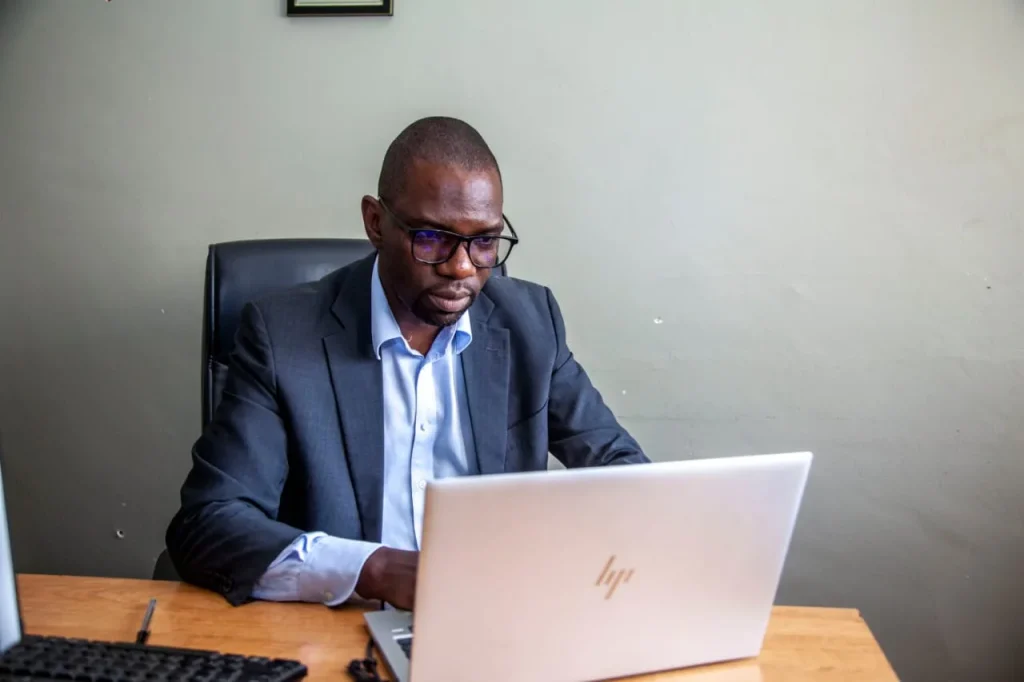 Economist Kelvin Chisanga working at a laptop