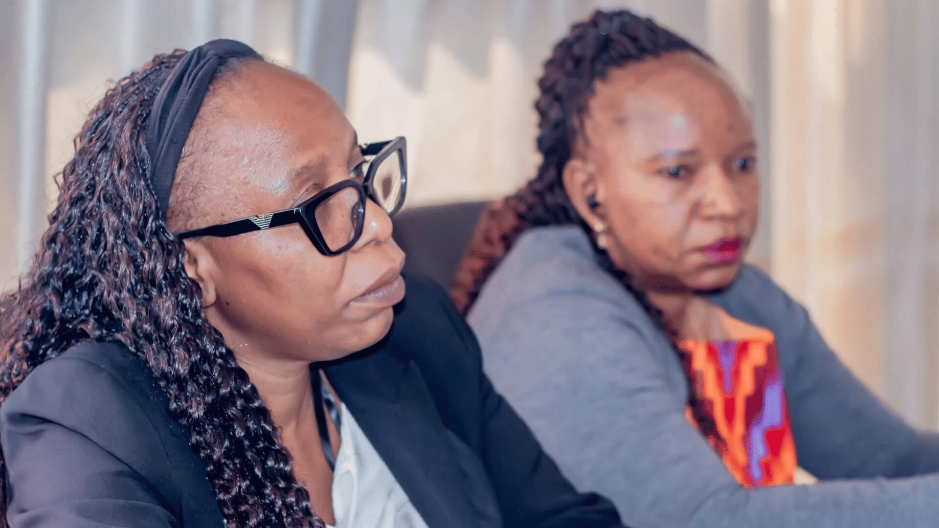 Two women listen during a Copperbelt stakeholder meeting on the Pension Laws of 2026.