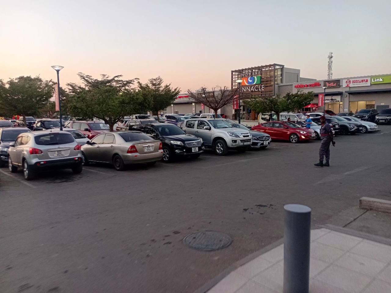 Vehicles filling the Novare Pinnacle Mall parking area in Woodlands, Lusaka, during an evening field visit