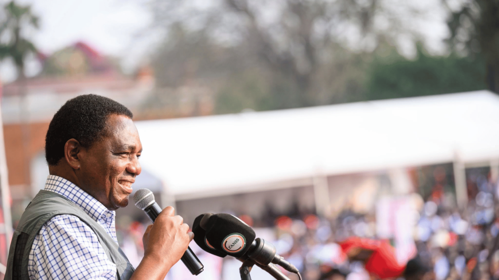 President Hakainde Hichilema speaking into a microphone during a student gathering at State House in Lusaka