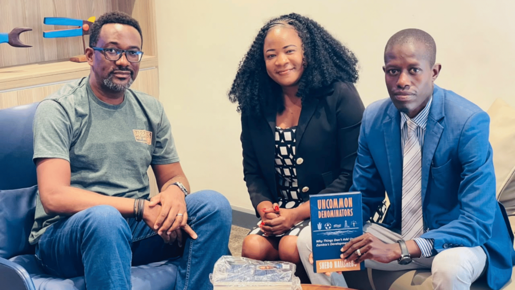 EAZ National Secretary Dr Nicholus Mainza with a copy of Uncommon Denominators by Shebo Nalishebo