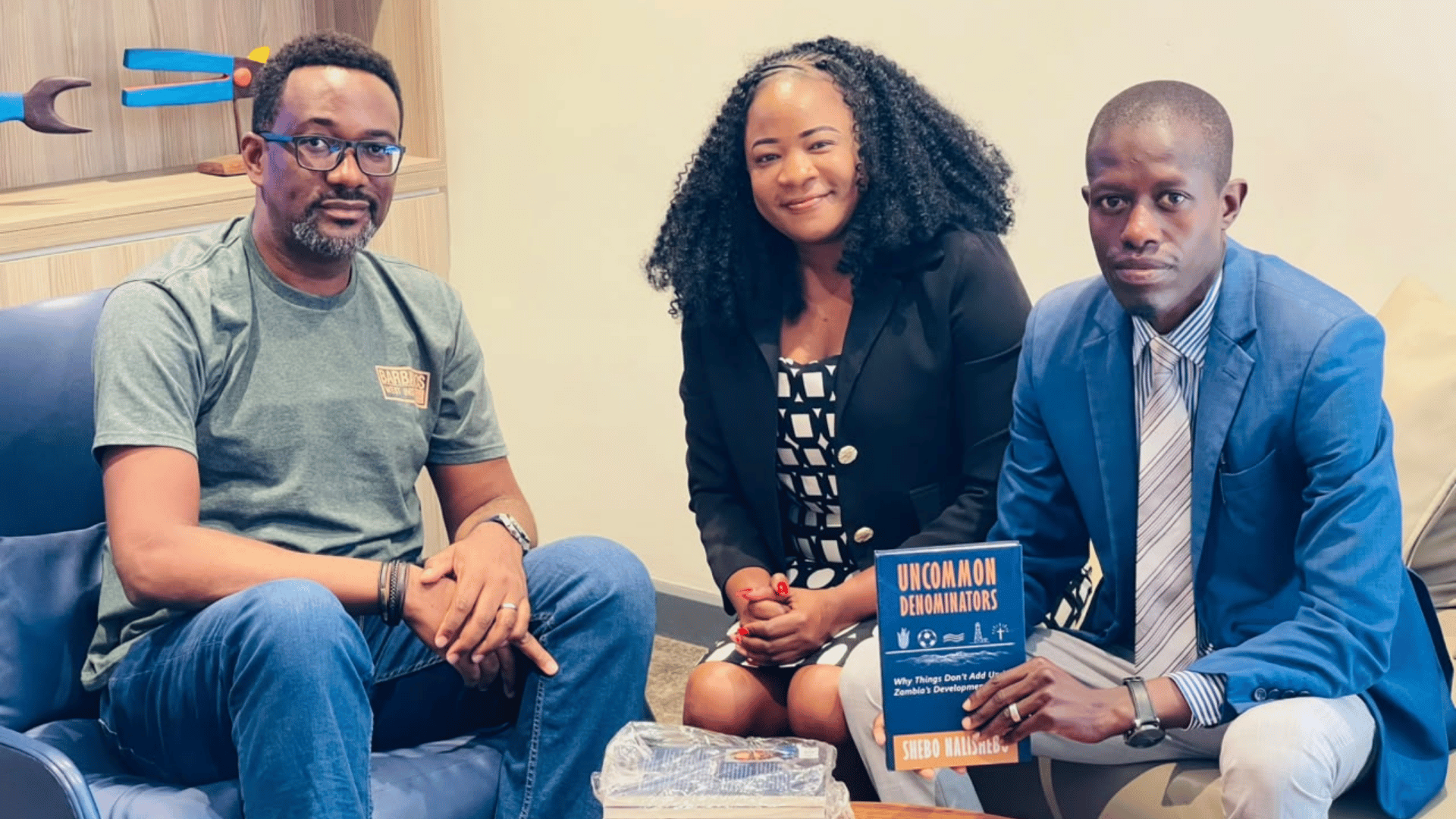 EAZ National Secretary Dr Nicholus Mainza with a copy of Uncommon Denominators by Shebo Nalishebo