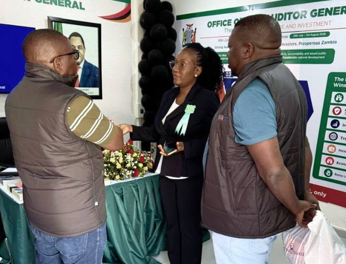 Theresa Machimu, Principal Planner, speaks with visitors at the OAG stand