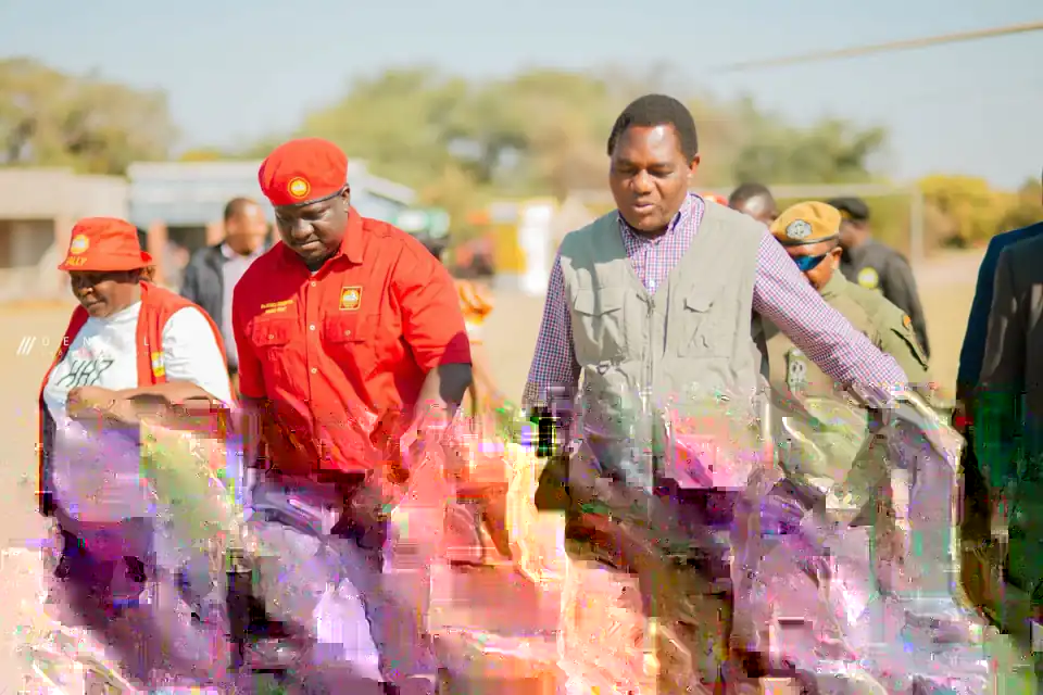 Imanga Wamunyima Jr walks alongside President Hakainde Hichilema at a campaign event in Nalolo, Western Province