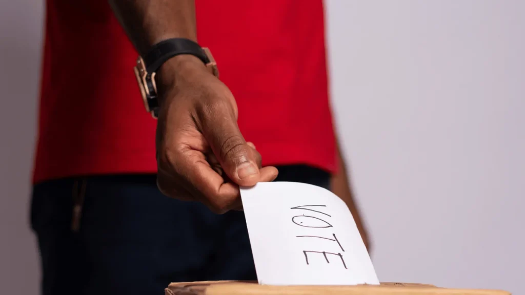 A voter placing a marked voting paper into a ballot box ahead of Zambia’s 13 August 2026 election.