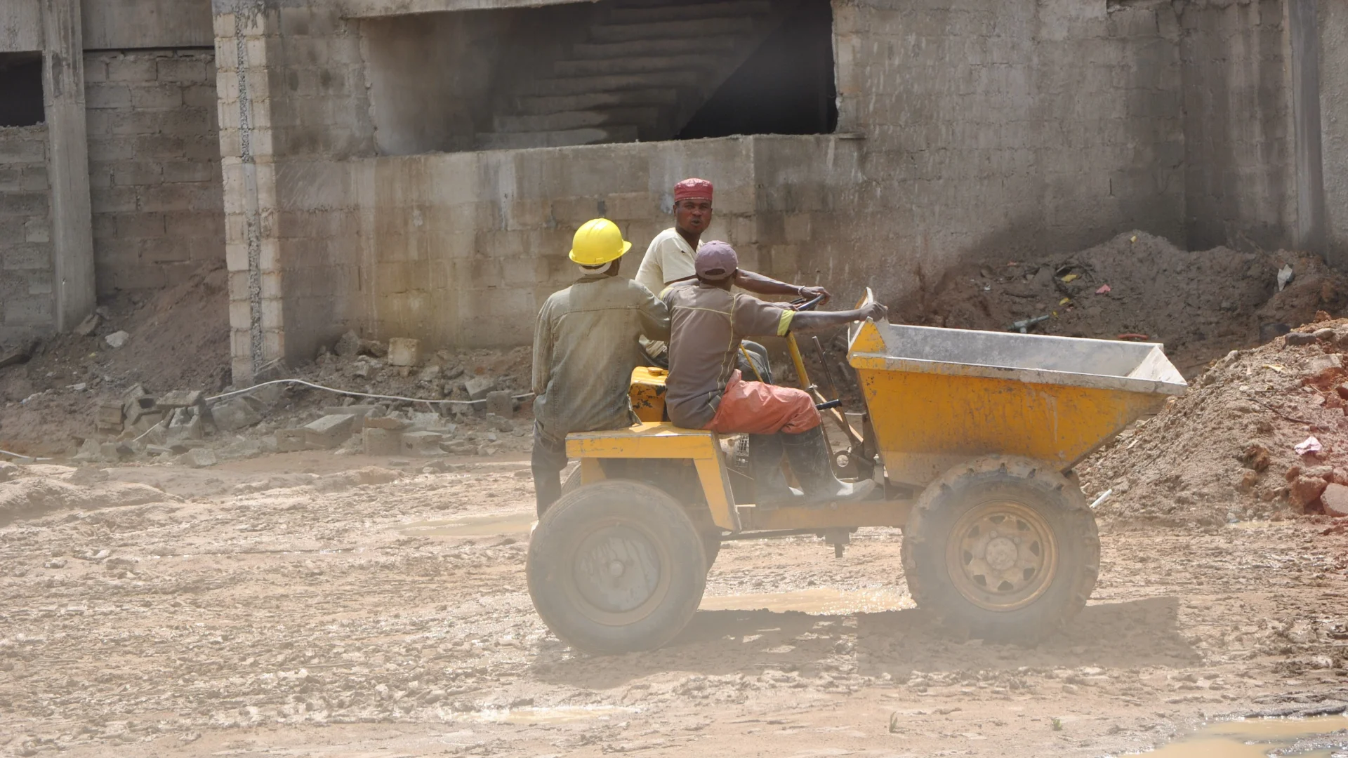 Construction workers on a building site in Zambia, illustrating the case for national CDF infrastructure cost benchmarks