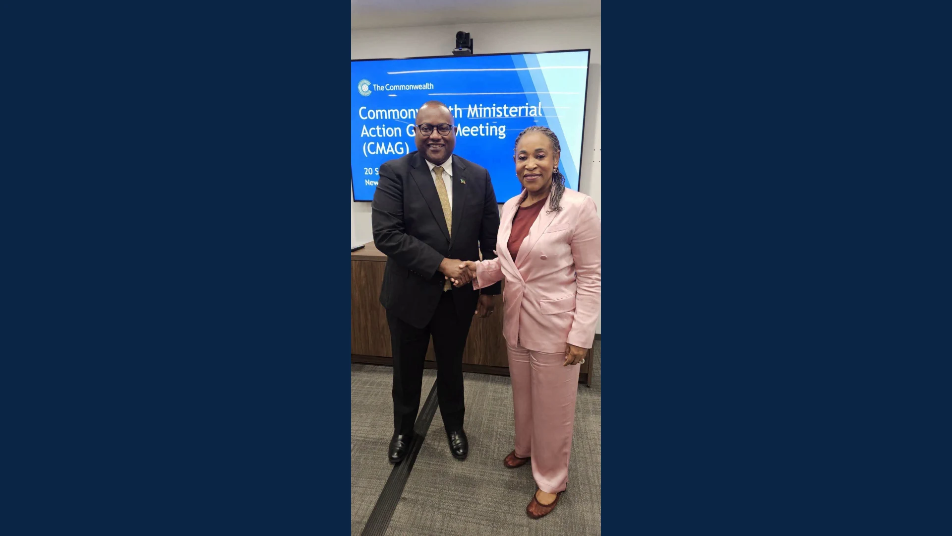 Zambia's Foreign Affairs Minister Mulambo Haimbe shakes hands with Commonwealth Secretary-General Shirley Botchwey at the 74th Extraordinary Meeting of the Commonwealth Ministerial Action Group in New York