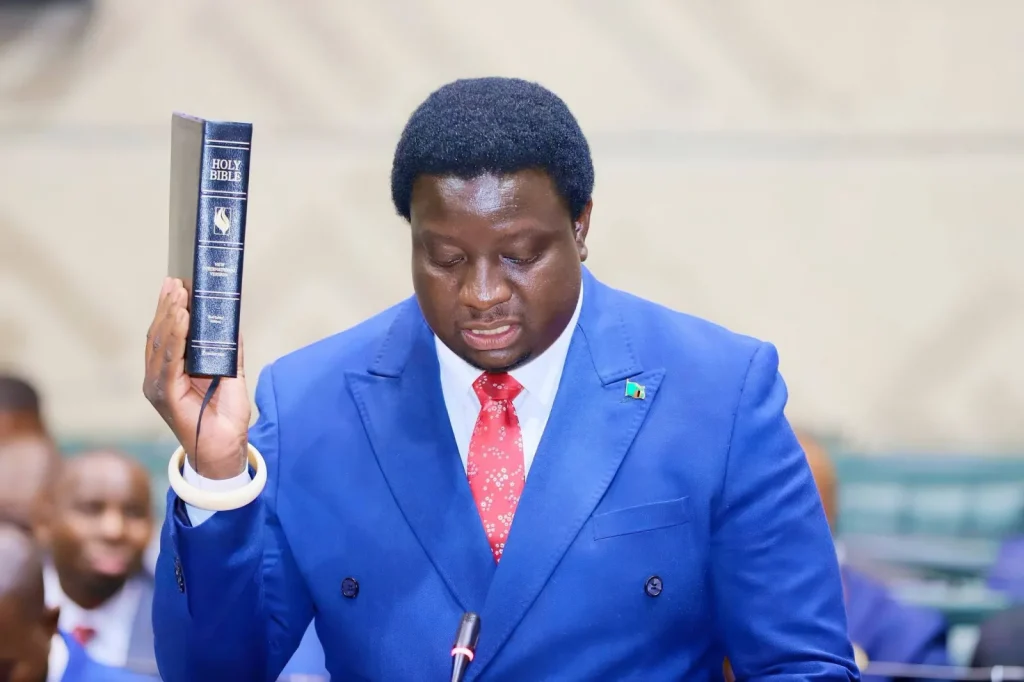 Imanga Wamunyima Jr holds a Bible while taking the oath of office for Nalolo