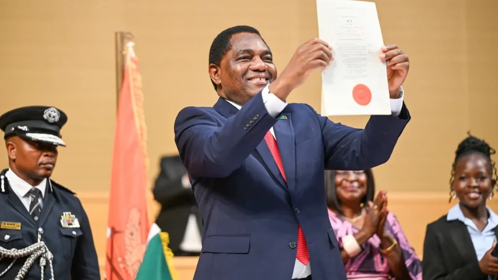 President Hakainde Hichilema holds up the signed Constitutional Amendment Bill of 2025 that created 40 Parliament PR seats