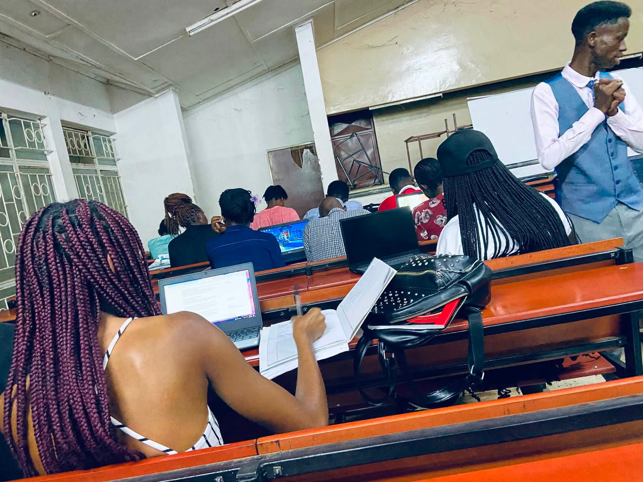 Students working with laptops and notes during KNEBA’s research fellowship classroom session.