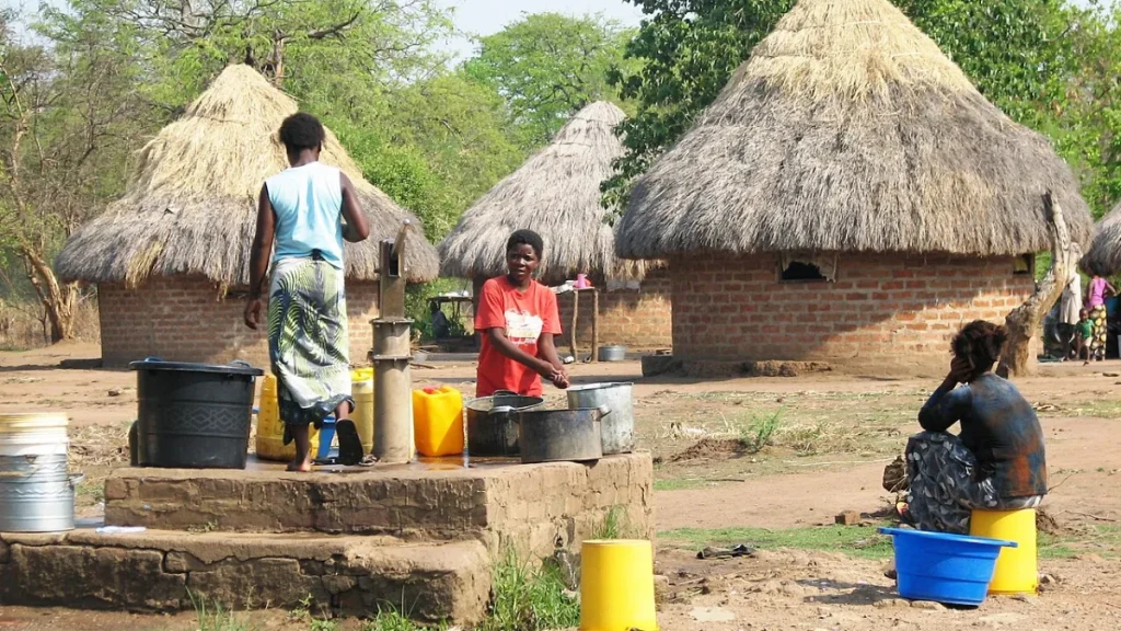 Women drawing water from a hand-dug well in a rural Zambian community