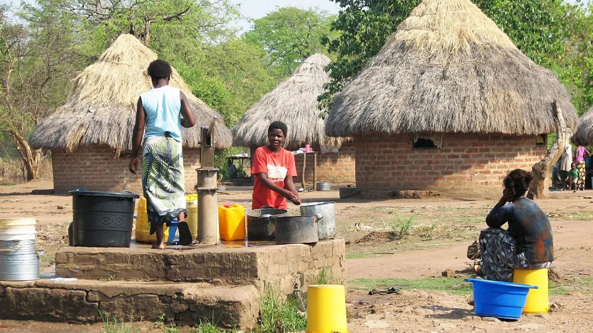 Women drawing water from a hand-dug well in a rural Zambian community