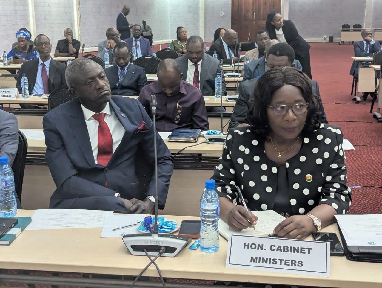 A delegate taking notes beside an HON. CABINET MINISTERS name plate during the 2027 Budget orientation