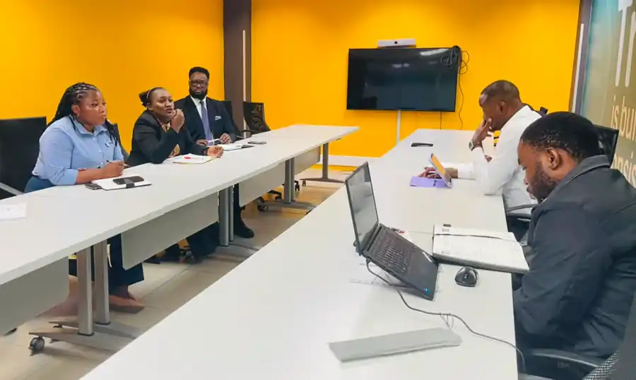 Economics Association of Zambia and FNB Zambia officials in discussion across a boardroom table