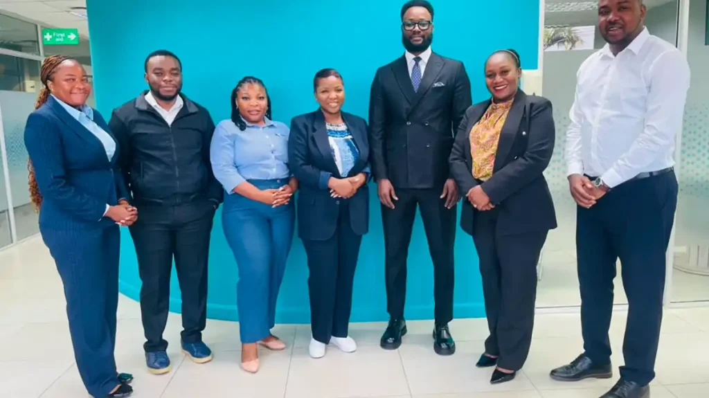 Economics Association of Zambia and FNB Zambia teams pose together after their partnership meeting in Lusaka