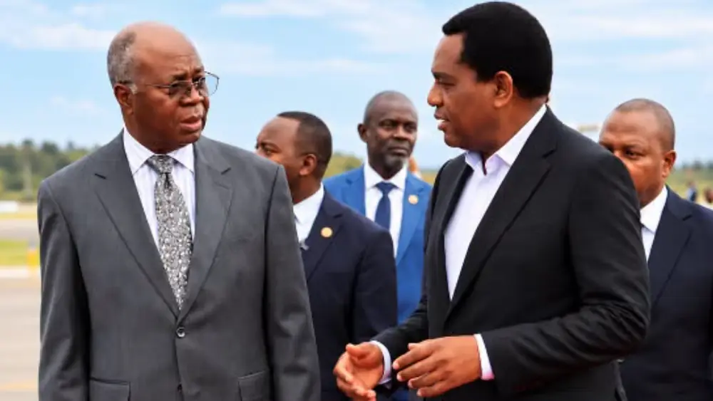 President Hakainde Hichilema talks with Finance Minister Situmbeko Musokotwane on the tarmac at Kenneth Kaunda International Airport after returning from the UAE