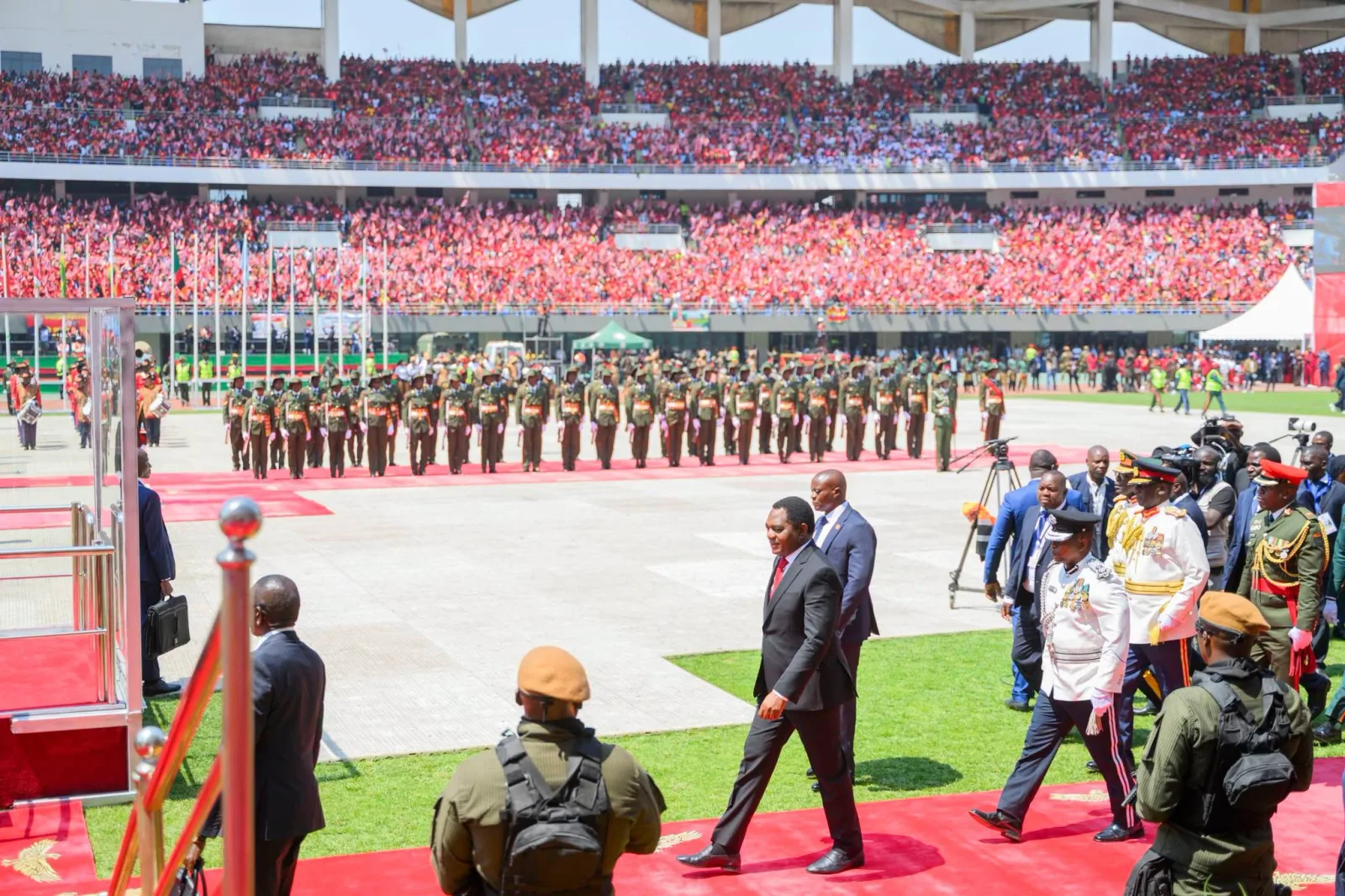 President Hakainde Hichilema walks past a military guard of honour in a packed stadium at his second inauguration on 1 September 2026