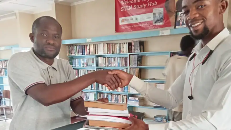 Library Development Foundation representative hands over donated books at the Luapula Provincial Library STEM Study Hub in Mansa