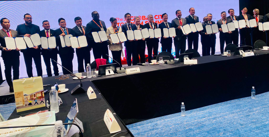 Mayors and delegates display signed documents at the second Global City Tourism Summit in Busan, South Korea.