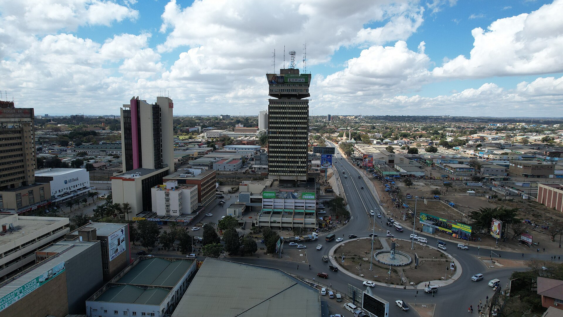 Aerial view of central Lusaka under strong sunlight with sparse tree cover and sprawling low-rise suburbs, illustrating urban heat during the 2026 super El Niño