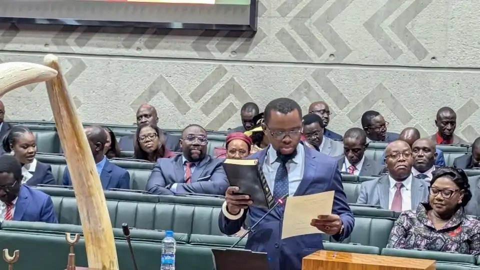 Sesheke East MP Romeo Kangombe reads from a document in the chamber of the National Assembly of Zambia