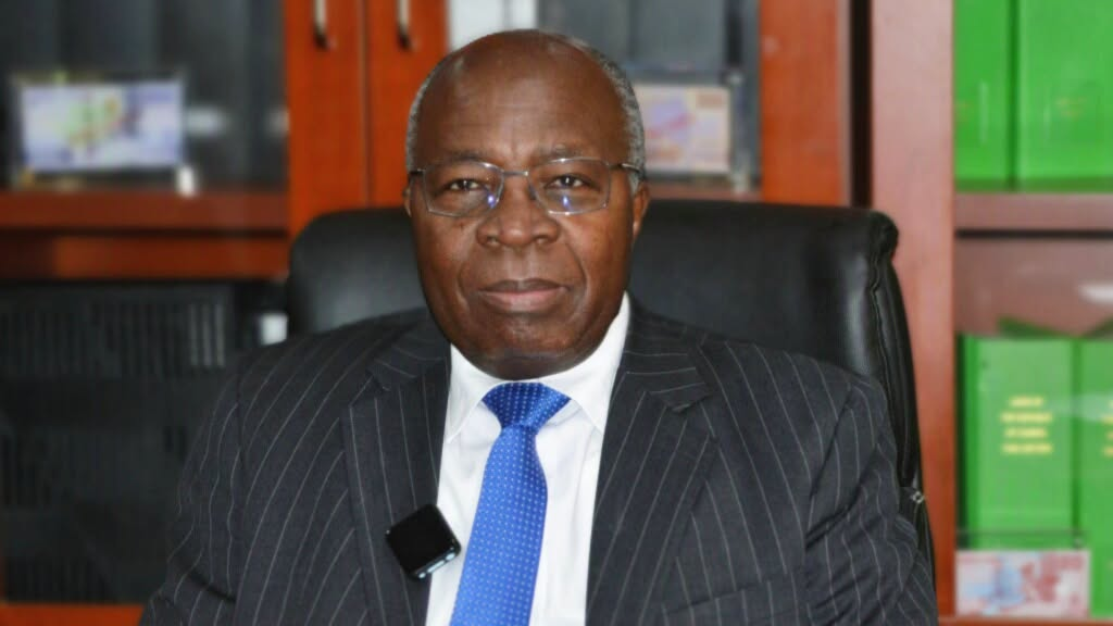 Dr Situmbeko Musokotwane seated in an office, wearing a dark suit and blue tie.