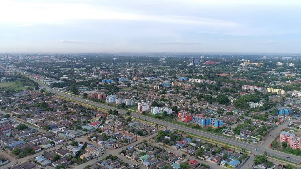 Aerial view of Lusaka, Zambia, with a main road running through residential and commercial districts towards the city centre