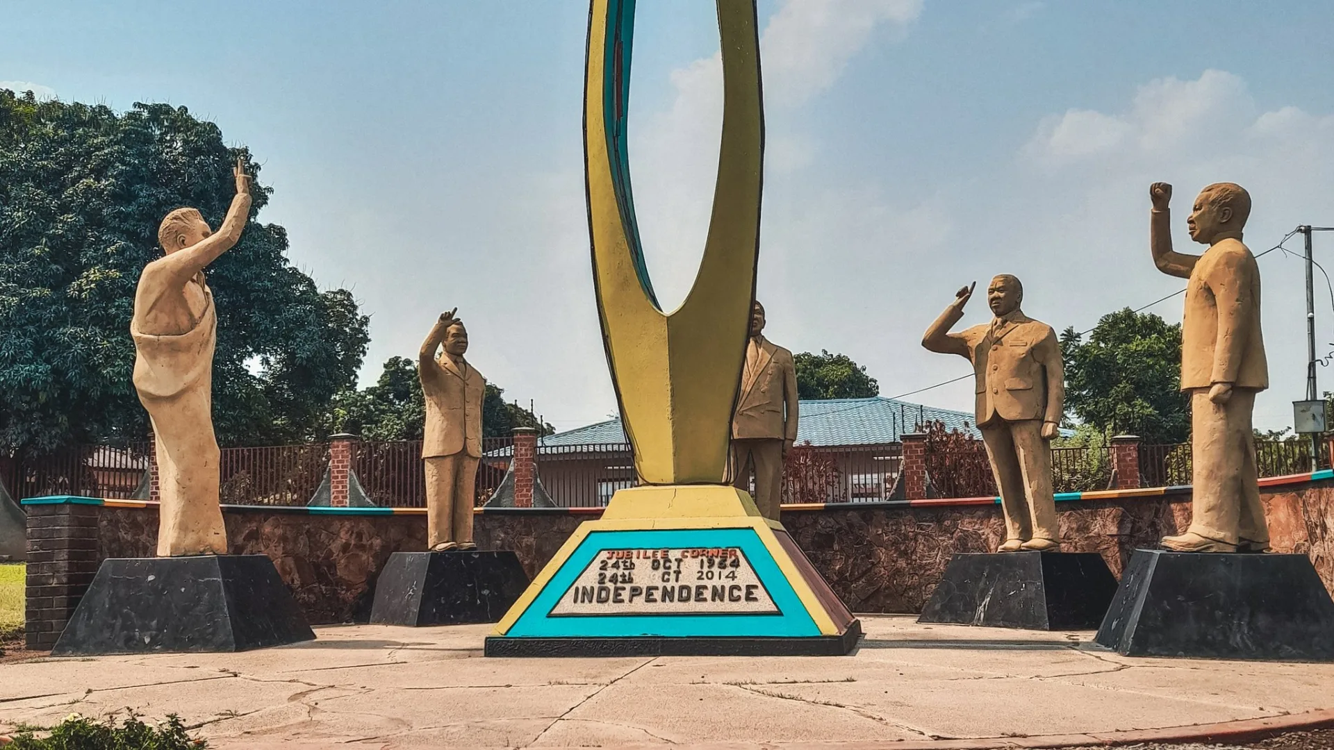 Independence Monument in Ndola, Zambia, with statues of the country's presidents and a plaque marking Independence on 24 October 1964