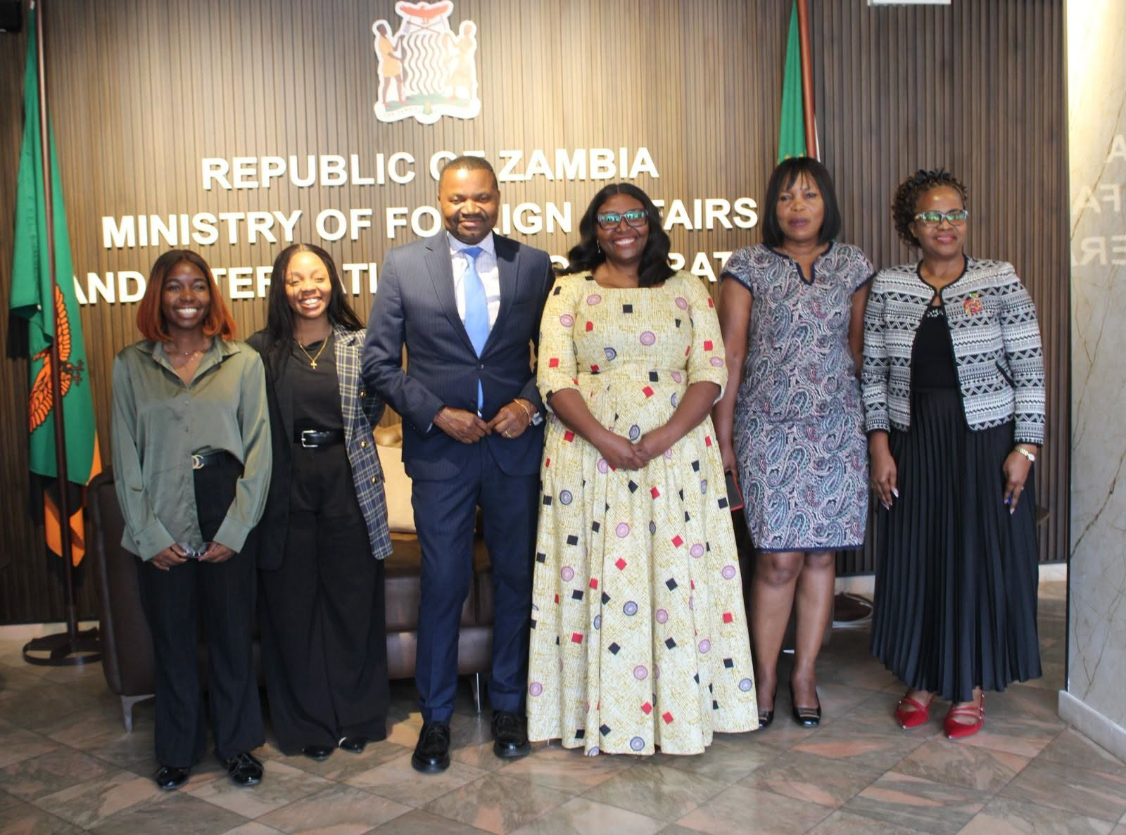 Officials pose together at Zambia’s Ministry of Foreign Affairs and International Cooperation following a meeting on African Hydro Symposium preparations.