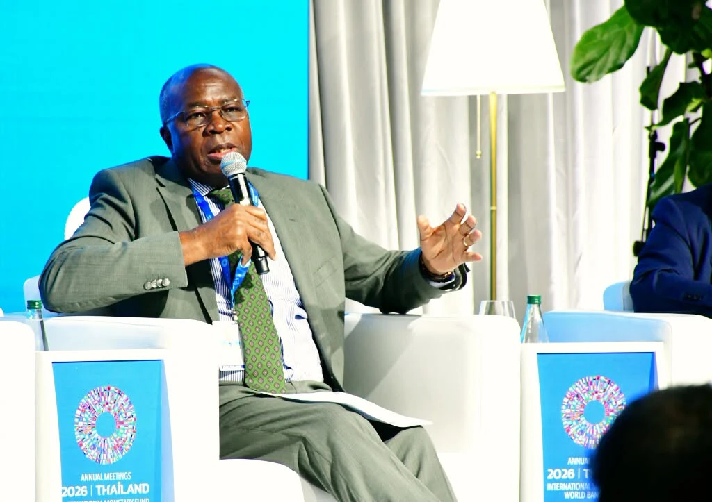 Finance Minister Situmbeko Musokotwane speaking into a microphone at a panel discussion